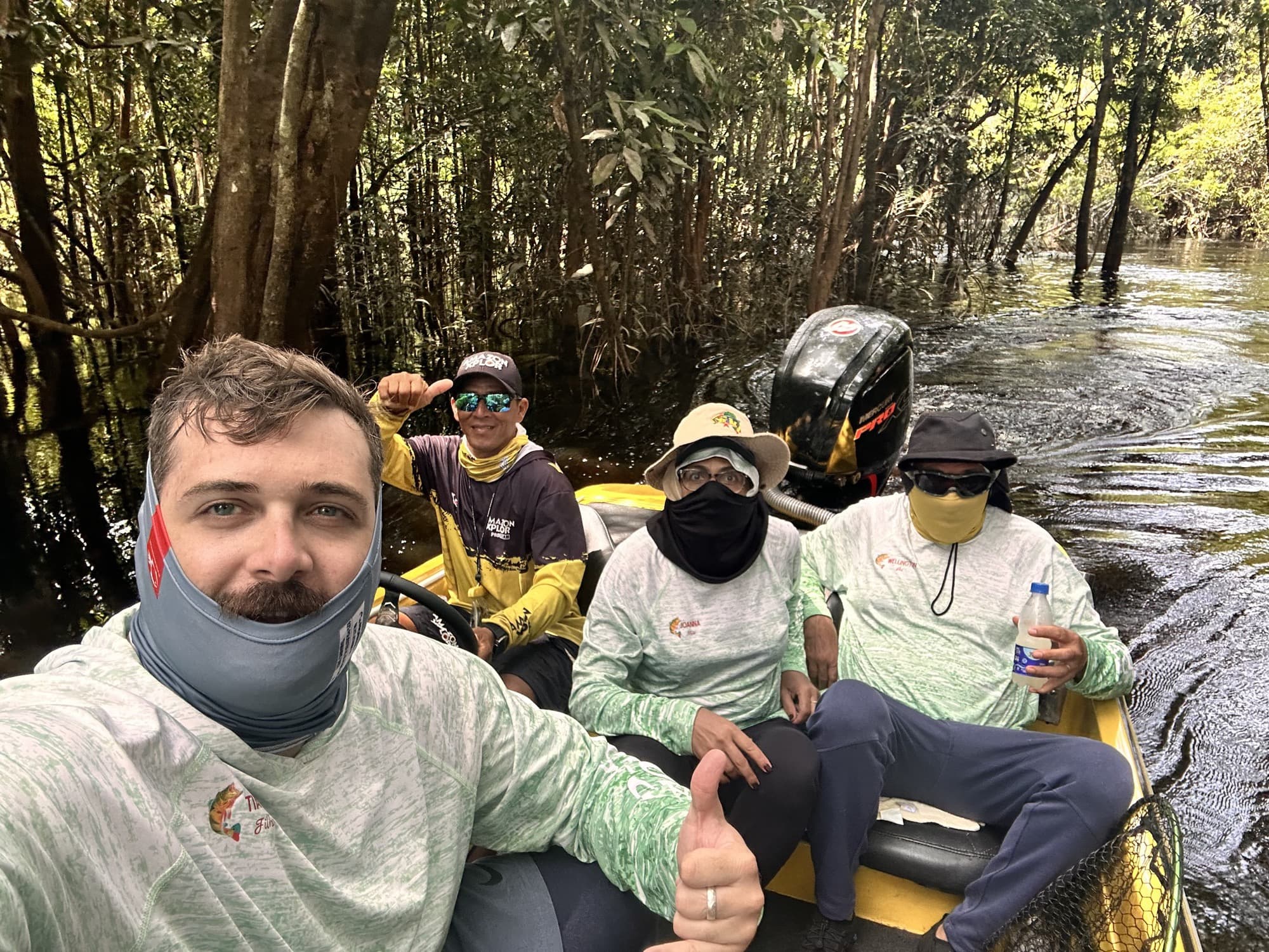 Tiago with a group on a boat in the Amazon mangroves