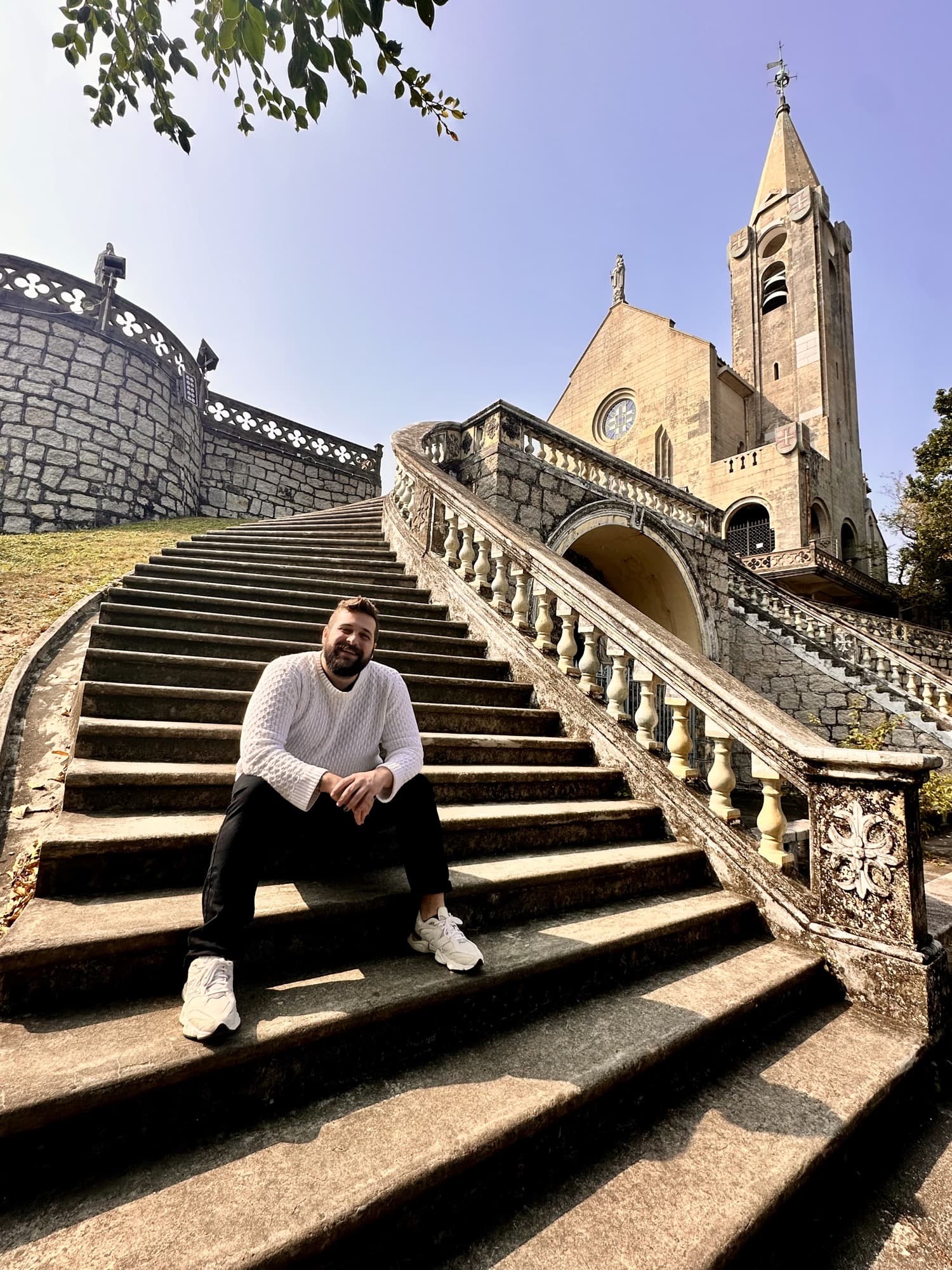 Tiago sitting on stone church steps